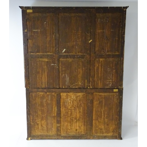 1726 - A large Georgian mahogany bookcase with a moulded cornice above three astragal glazed doors and the ... 