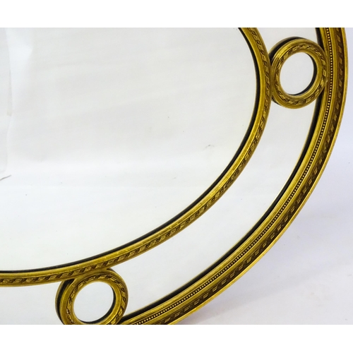 1612 - An early / mid 20thC gilt oval mirror. 38