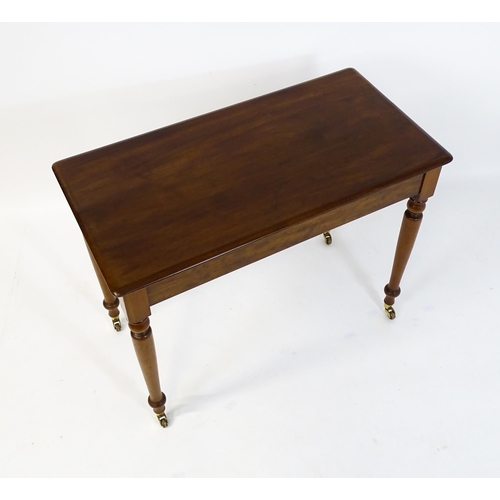 1620 - An early 20thC mahogany side table with a moulded rectangular top above four turned tapering legs te... 