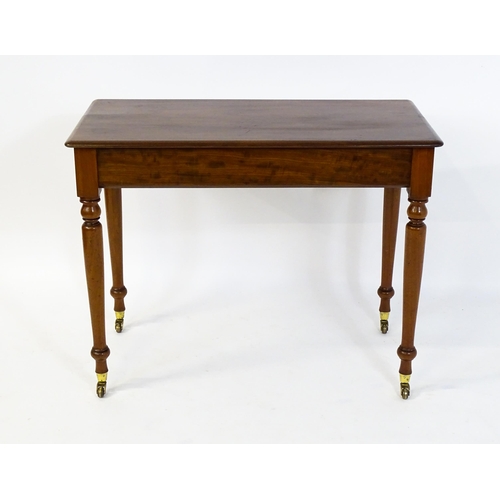 1620 - An early 20thC mahogany side table with a moulded rectangular top above four turned tapering legs te... 