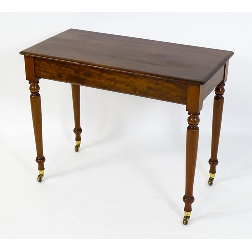 1620 - An early 20thC mahogany side table with a moulded rectangular top above four turned tapering legs te... 