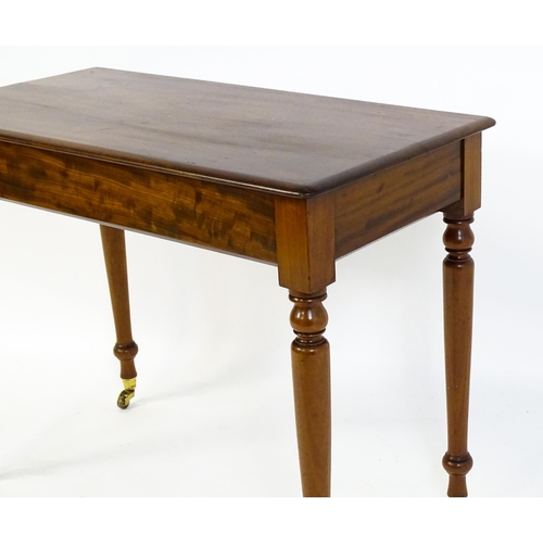 1620 - An early 20thC mahogany side table with a moulded rectangular top above four turned tapering legs te... 