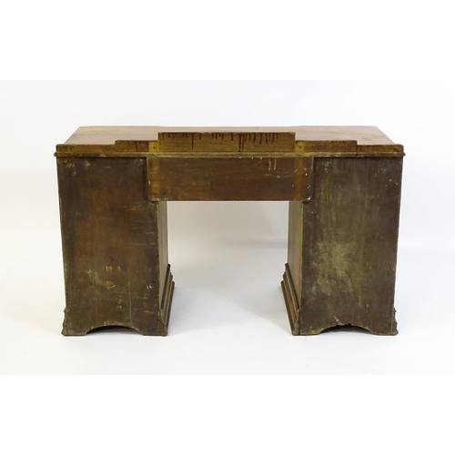 1621 - An Art Deco oak desk / dressing table with a shaped upstand, inverted breakfront top and fluted pila... 