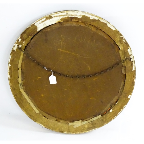 1648 - A late 19thC / early 20thC circular gilt mirror with applied ball decoration. 24