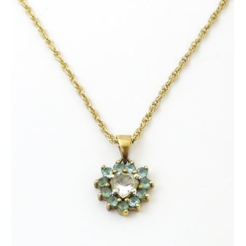 731 - A 9ct gold pendant and chain, the pendant set with white and aqua coloured stones.  Chain approx 20