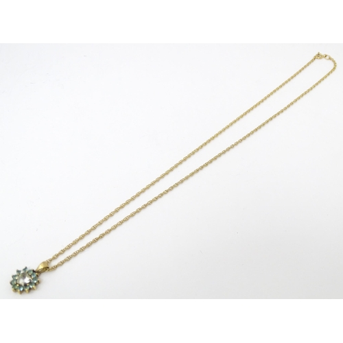 731 - A 9ct gold pendant and chain, the pendant set with white and aqua coloured stones.  Chain approx 20