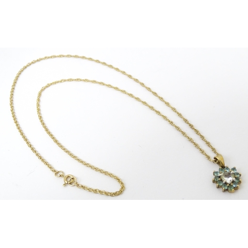 731 - A 9ct gold pendant and chain, the pendant set with white and aqua coloured stones.  Chain approx 20