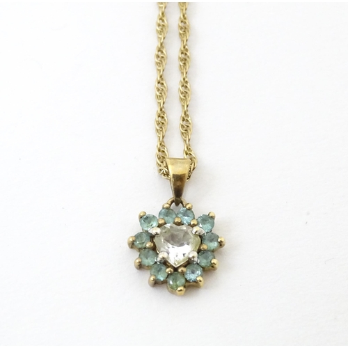 731 - A 9ct gold pendant and chain, the pendant set with white and aqua coloured stones.  Chain approx 20