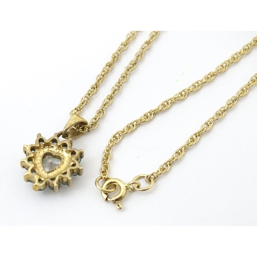 731 - A 9ct gold pendant and chain, the pendant set with white and aqua coloured stones.  Chain approx 20