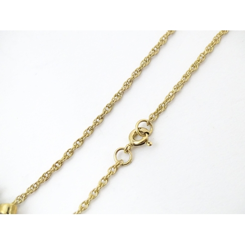 731 - A 9ct gold pendant and chain, the pendant set with white and aqua coloured stones.  Chain approx 20