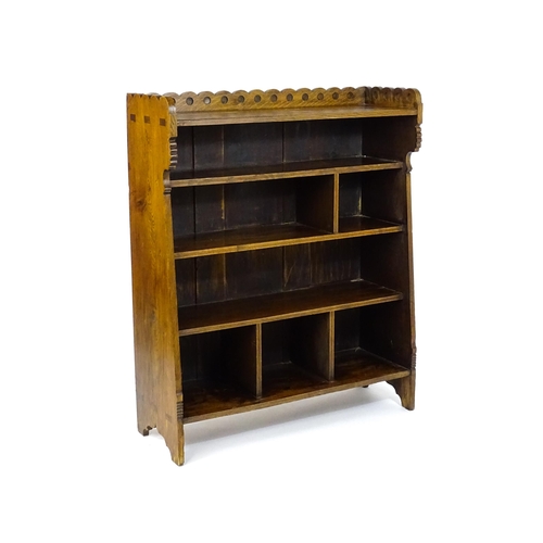 1592 - A late 19thC Arts & Crafts, Charles Lock Eastlake oak bookcase, with a shaped upstand decorated with... 