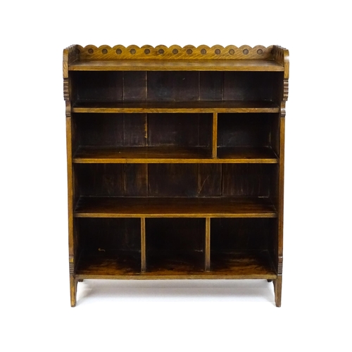 1592 - A late 19thC Arts & Crafts, Charles Lock Eastlake oak bookcase, with a shaped upstand decorated with... 