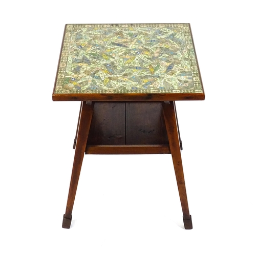 1607 - A late 19thC / early 20thC Arts and Crafts cigar table, the glass top sitting above a collage of cig... 