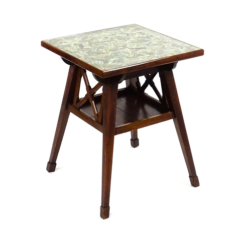 1607 - A late 19thC / early 20thC Arts and Crafts cigar table, the glass top sitting above a collage of cig... 