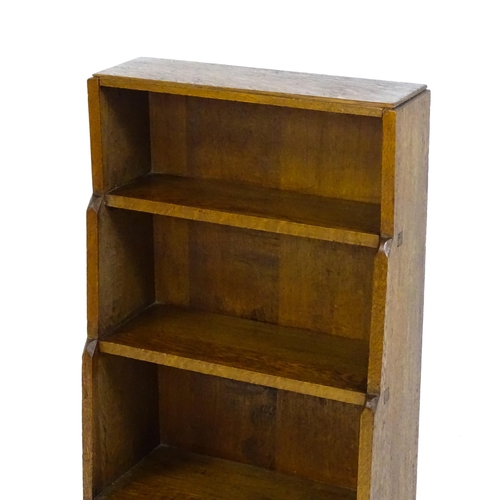 1608 - An Arts & Crafts, Cotswold School, oak waterfall style bookcase raised on four tapering legs. 20