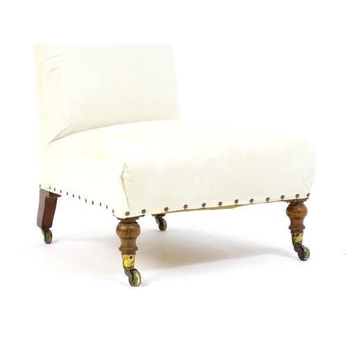 1634 - A 19thC Howard & Sons style slipper chair raised on turned front legs and shaped block back legs ter... 