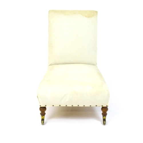 1634 - A 19thC Howard & Sons style slipper chair raised on turned front legs and shaped block back legs ter... 