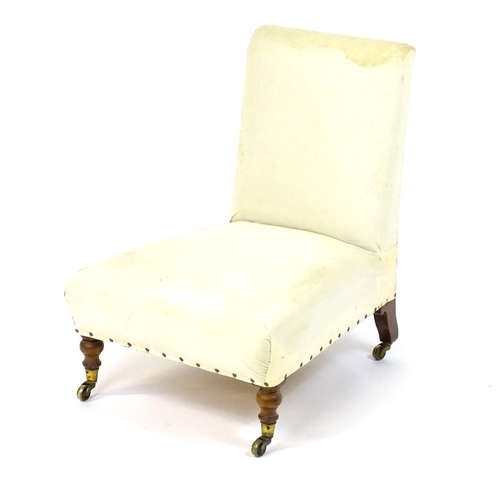 1634 - A 19thC Howard & Sons style slipper chair raised on turned front legs and shaped block back legs ter... 