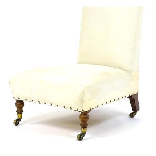 1634 - A 19thC Howard & Sons style slipper chair raised on turned front legs and shaped block back legs ter... 