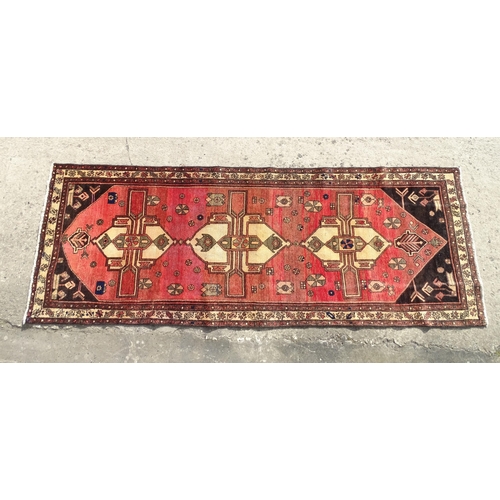 1495 - Carpet / Rug :  A North West Persian Heriz runner, the cream,  red and black grounds with geometric ... 