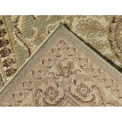 1497 - Carpet / Rug : A square rug with beige and sage green grounds decorated with central medallion  bord... 