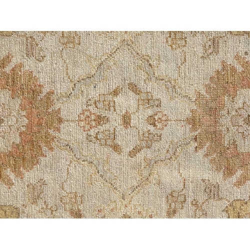 1510 - Carpet / Rug : A wool carpet, the beige ground with floral and foliate detail, with further floral d... 