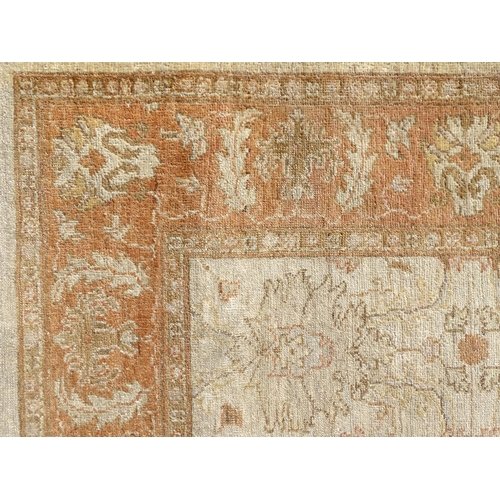 1510 - Carpet / Rug : A wool carpet, the beige ground with floral and foliate detail, with further floral d... 