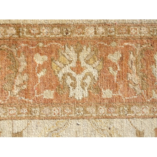 1510 - Carpet / Rug : A wool carpet, the beige ground with floral and foliate detail, with further floral d... 