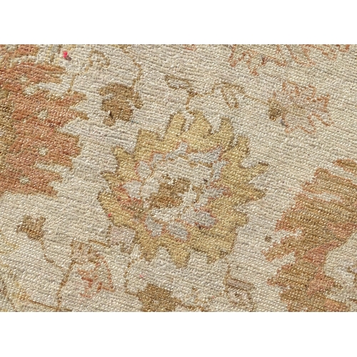 1510 - Carpet / Rug : A wool carpet, the beige ground with floral and foliate detail, with further floral d... 