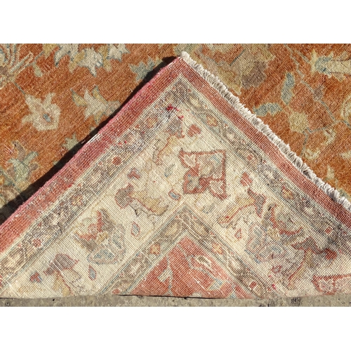 1511 - Carpet / Rug : A wool carpet, the salmon pink ground decorated with floral and foliate detail, with ... 