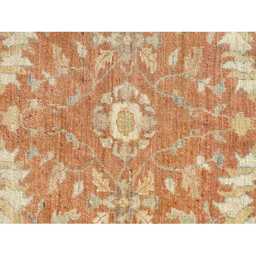 1511 - Carpet / Rug : A wool carpet, the salmon pink ground decorated with floral and foliate detail, with ... 