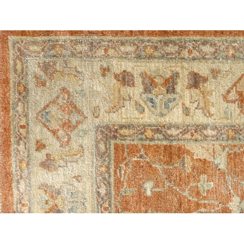 1511 - Carpet / Rug : A wool carpet, the salmon pink ground decorated with floral and foliate detail, with ... 