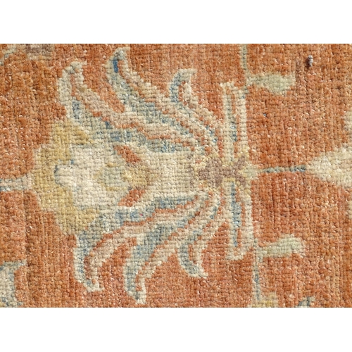 1511 - Carpet / Rug : A wool carpet, the salmon pink ground decorated with floral and foliate detail, with ... 