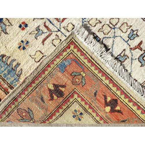 1513 - Carpet / Rug : A wool rug, the beige ground with foliate detail, with salmon ground border with scro... 