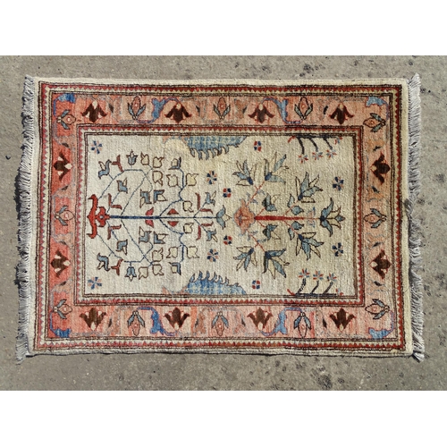 1513 - Carpet / Rug : A wool rug, the beige ground with foliate detail, with salmon ground border with scro... 