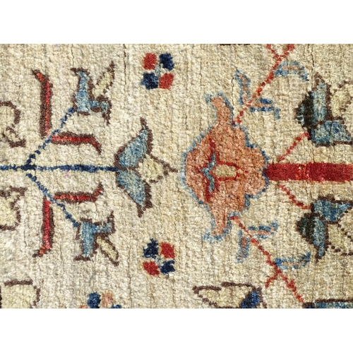 1513 - Carpet / Rug : A wool rug, the beige ground with foliate detail, with salmon ground border with scro... 