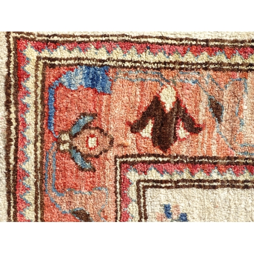 1513 - Carpet / Rug : A wool rug, the beige ground with foliate detail, with salmon ground border with scro... 