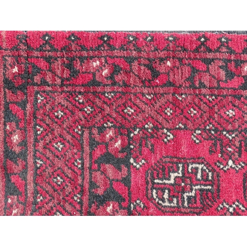 1514 - Carpet / Rug : A red ground runner with repeated geometric motifs and medallions. Approx. 115