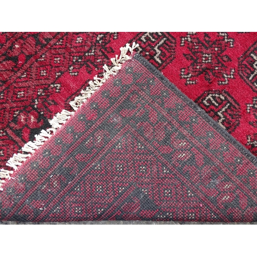 1514 - Carpet / Rug : A red ground runner with repeated geometric motifs and medallions. Approx. 115