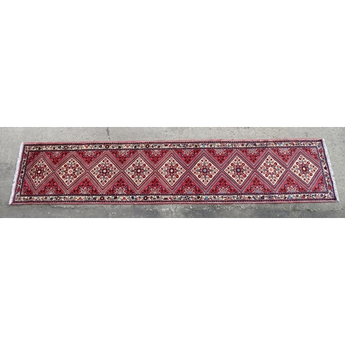 1521 - Carpet / Rug : A North West Persian Rudbar runner with red and cream ground having floral detail.  A... 