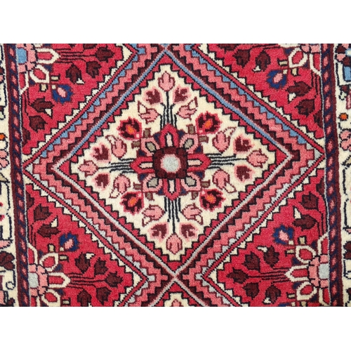 1521 - Carpet / Rug : A North West Persian Rudbar runner with red and cream ground having floral detail.  A... 