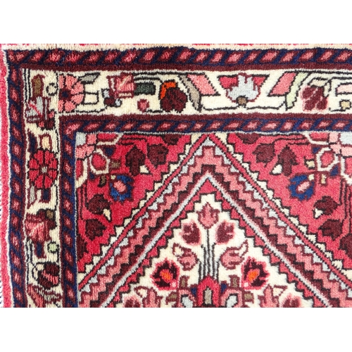 1521 - Carpet / Rug : A North West Persian Rudbar runner with red and cream ground having floral detail.  A... 