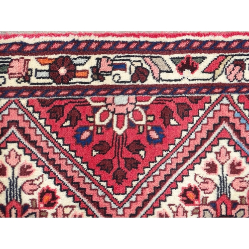 1521 - Carpet / Rug : A North West Persian Rudbar runner with red and cream ground having floral detail.  A... 