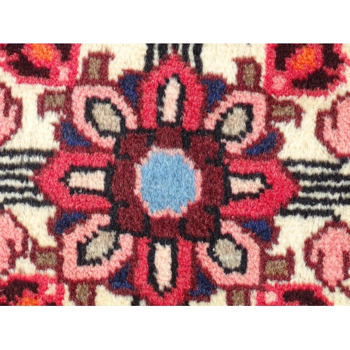 1521 - Carpet / Rug : A North West Persian Rudbar runner with red and cream ground having floral detail.  A... 