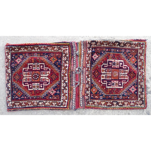 1529 - Rug : A woollen saddle bag style rug, decorated with stylised floral and geometric motifs. Approx 42... 