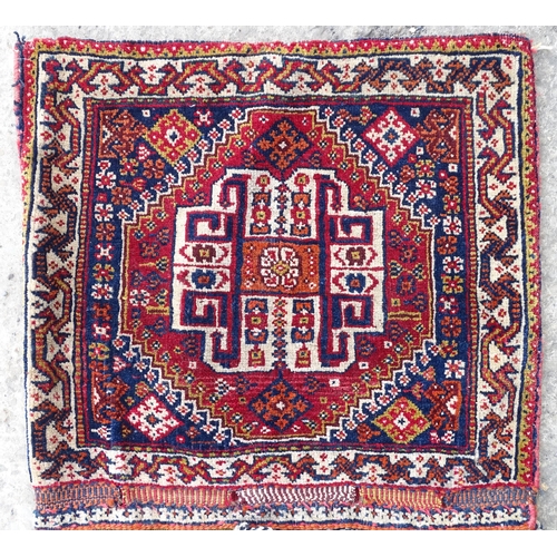 1529 - Rug : A woollen saddle bag style rug, decorated with stylised floral and geometric motifs. Approx 42... 