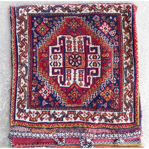 1529 - Rug : A woollen saddle bag style rug, decorated with stylised floral and geometric motifs. Approx 42... 