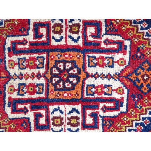 1529 - Rug : A woollen saddle bag style rug, decorated with stylised floral and geometric motifs. Approx 42... 