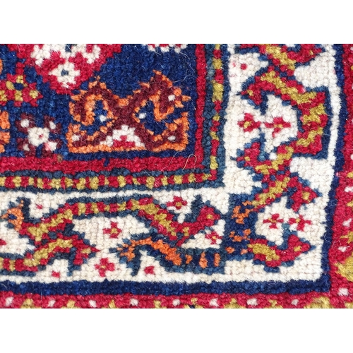 1529 - Rug : A woollen saddle bag style rug, decorated with stylised floral and geometric motifs. Approx 42... 