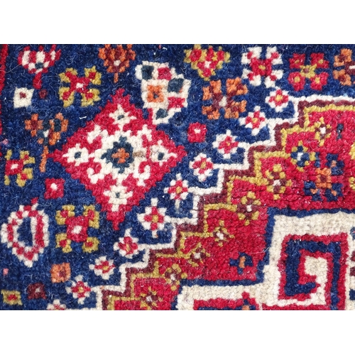 1529 - Rug : A woollen saddle bag style rug, decorated with stylised floral and geometric motifs. Approx 42... 